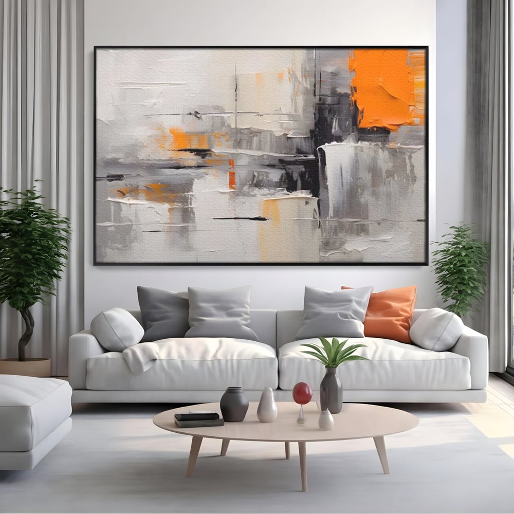 Tablou canvas cu pictura abstracta gri cu pata portocalie, in rama de aluminiu negru, pe perete intr-un living